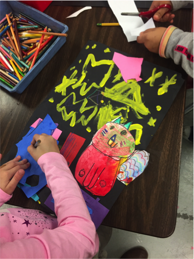 1st grade work on the details and background of their ?Night cat? collages.