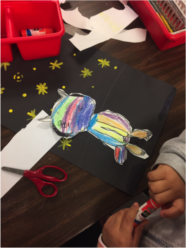 1st grade work on the details and background of their ?Night cat? collages.