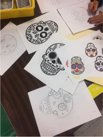 3rd grade working on design Sugar Skulls using mirrored/ reflective